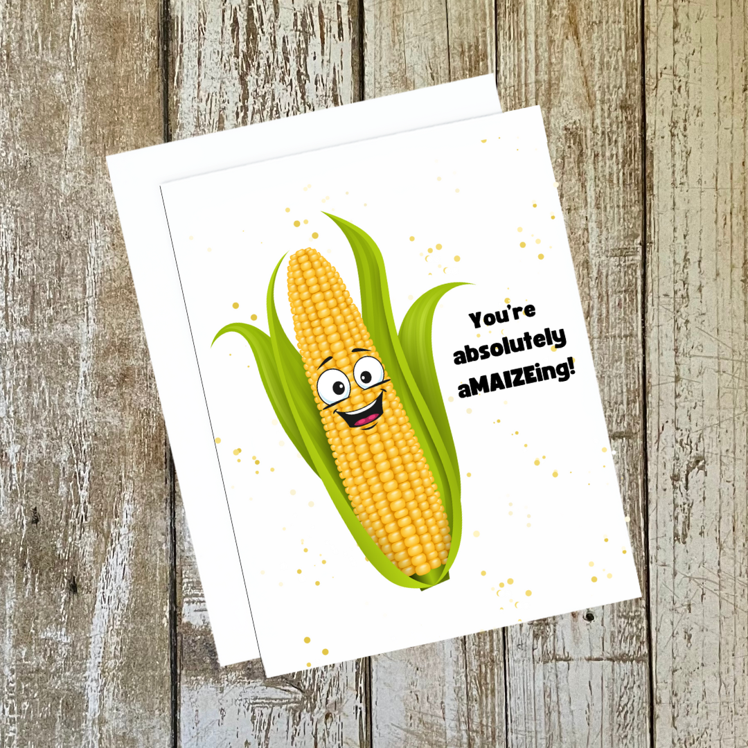 Funny greeting card. A graphic of a smiling corn cob. Text reads, You're Absolutely AMAIZEing!