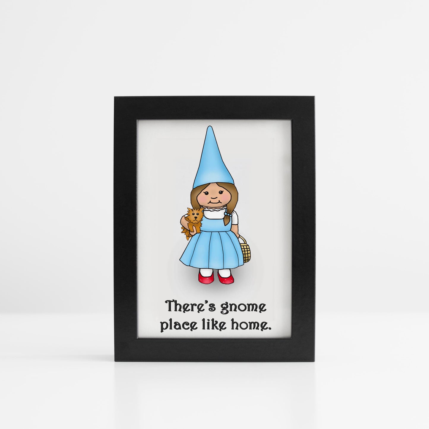 A photo of an art print. It has a gnome dressed like the Dorothy from The Wizard of Oz. Text reads, There's gnome place like home.
